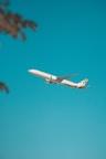 white airplane flying in the sky during daytime