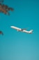white airplane flying in the sky during daytime