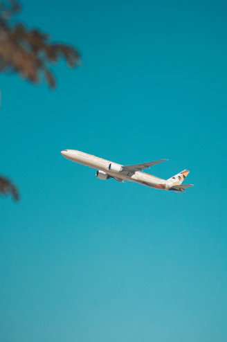 white airplane flying in the sky during daytime