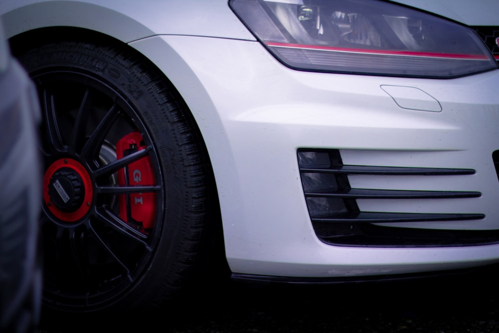 white car with black and red wheel