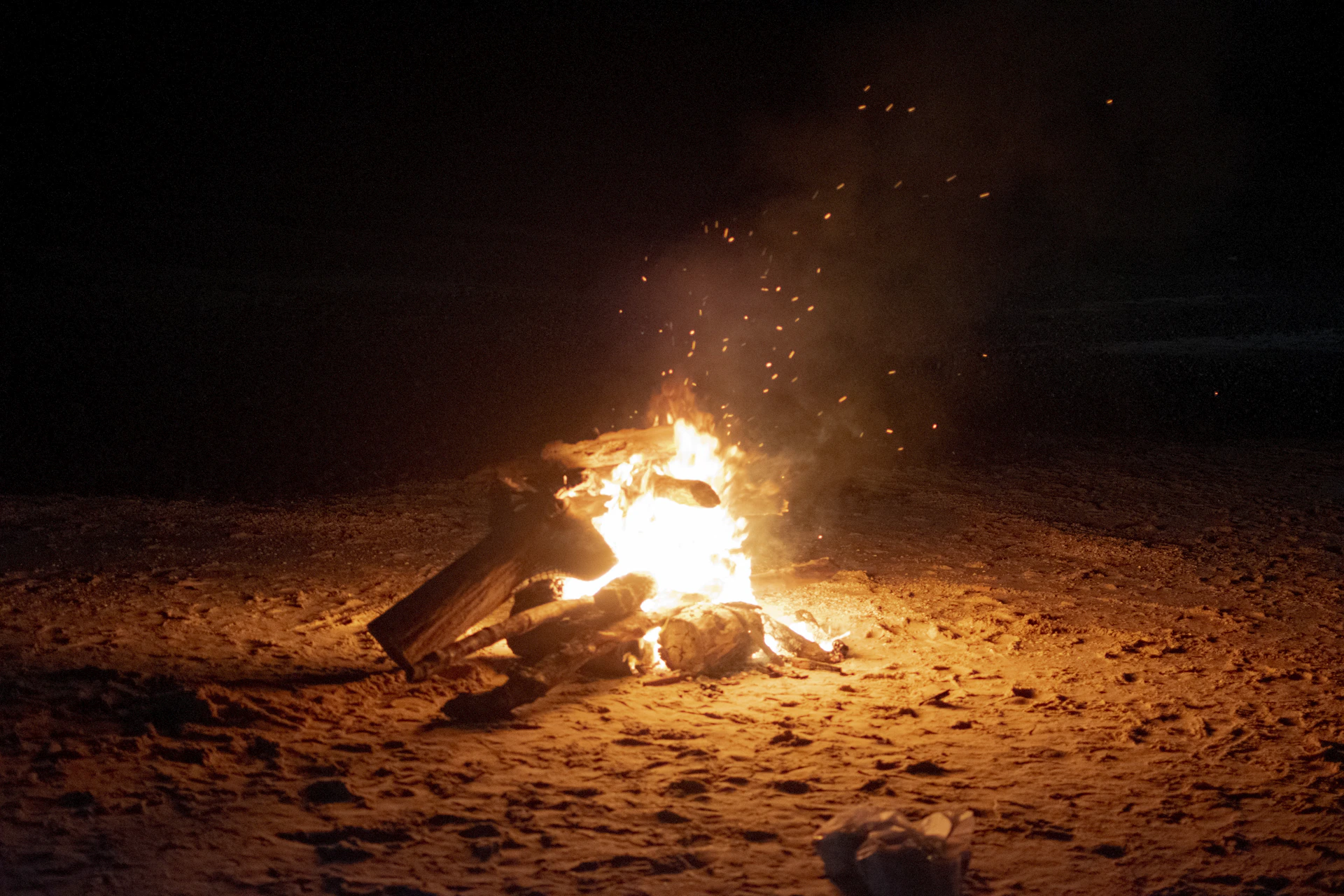 bonfire on brown sand during nighttime