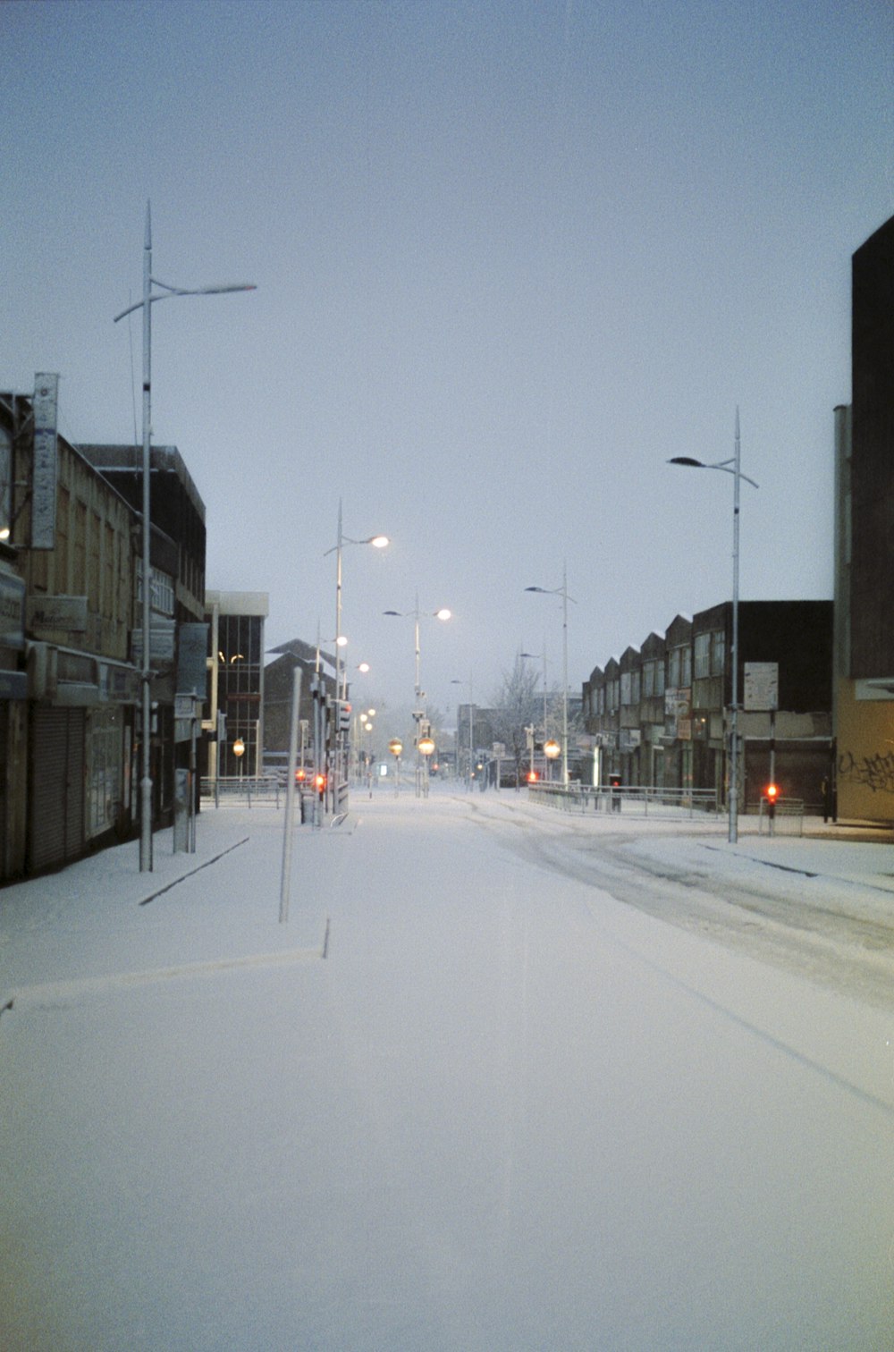 cars on road between buildings during daytime