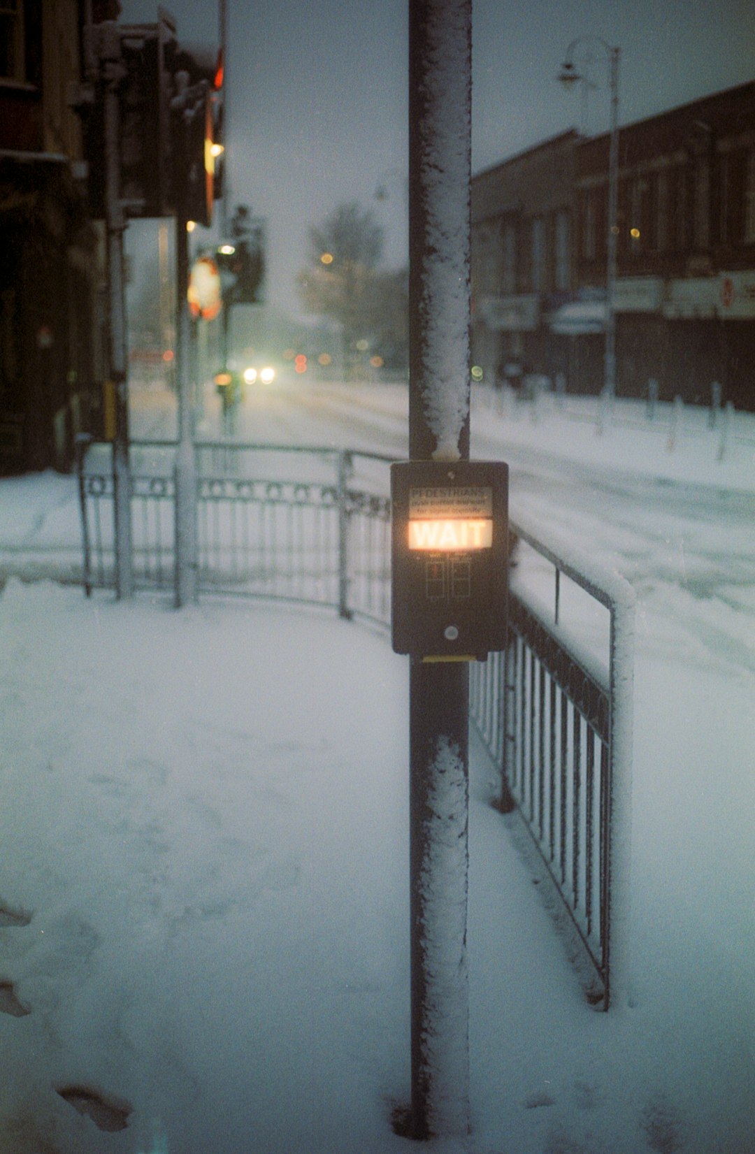 black street light on snow covered ground during night time