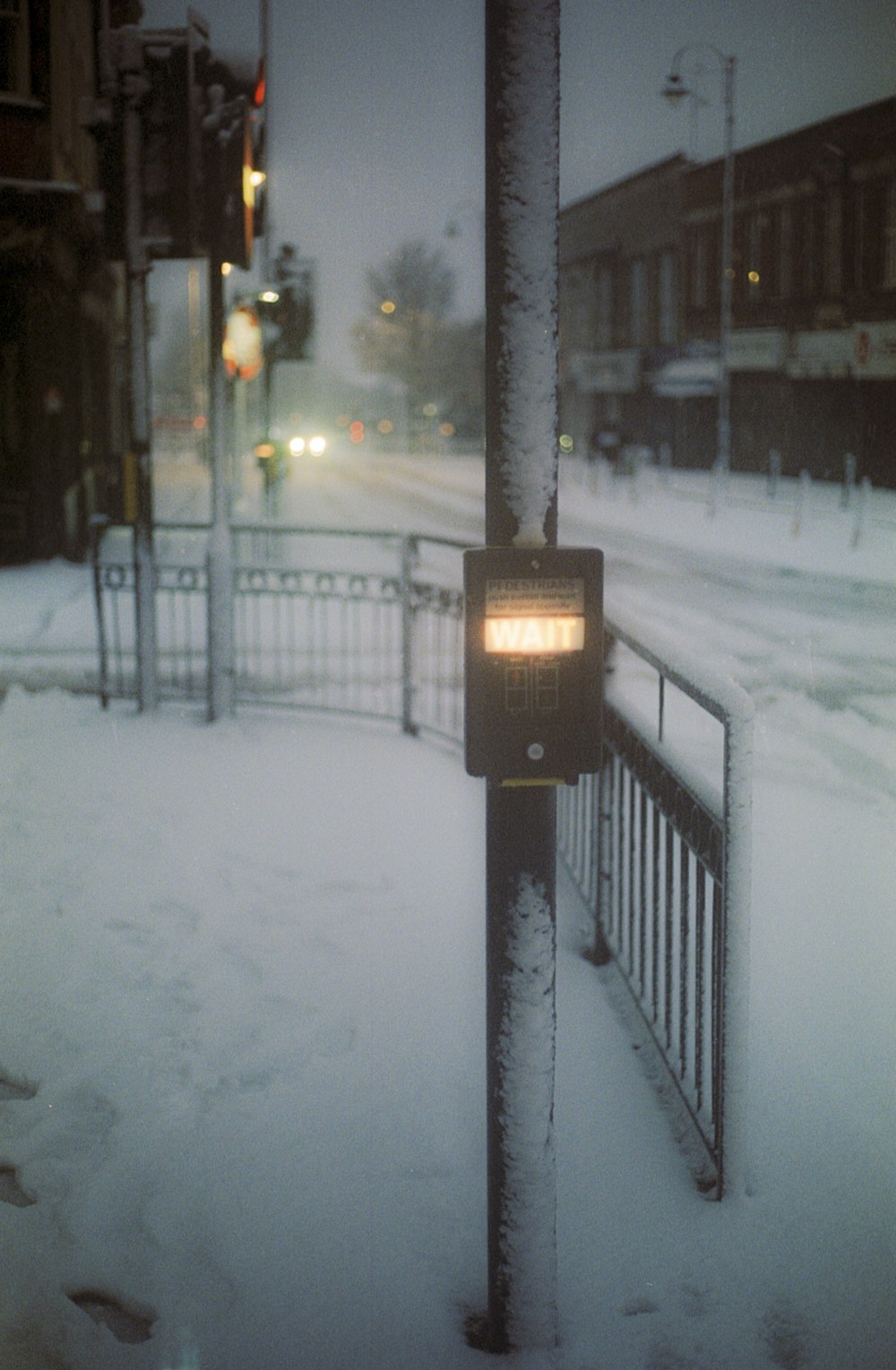 black street light on snow covered ground during night time