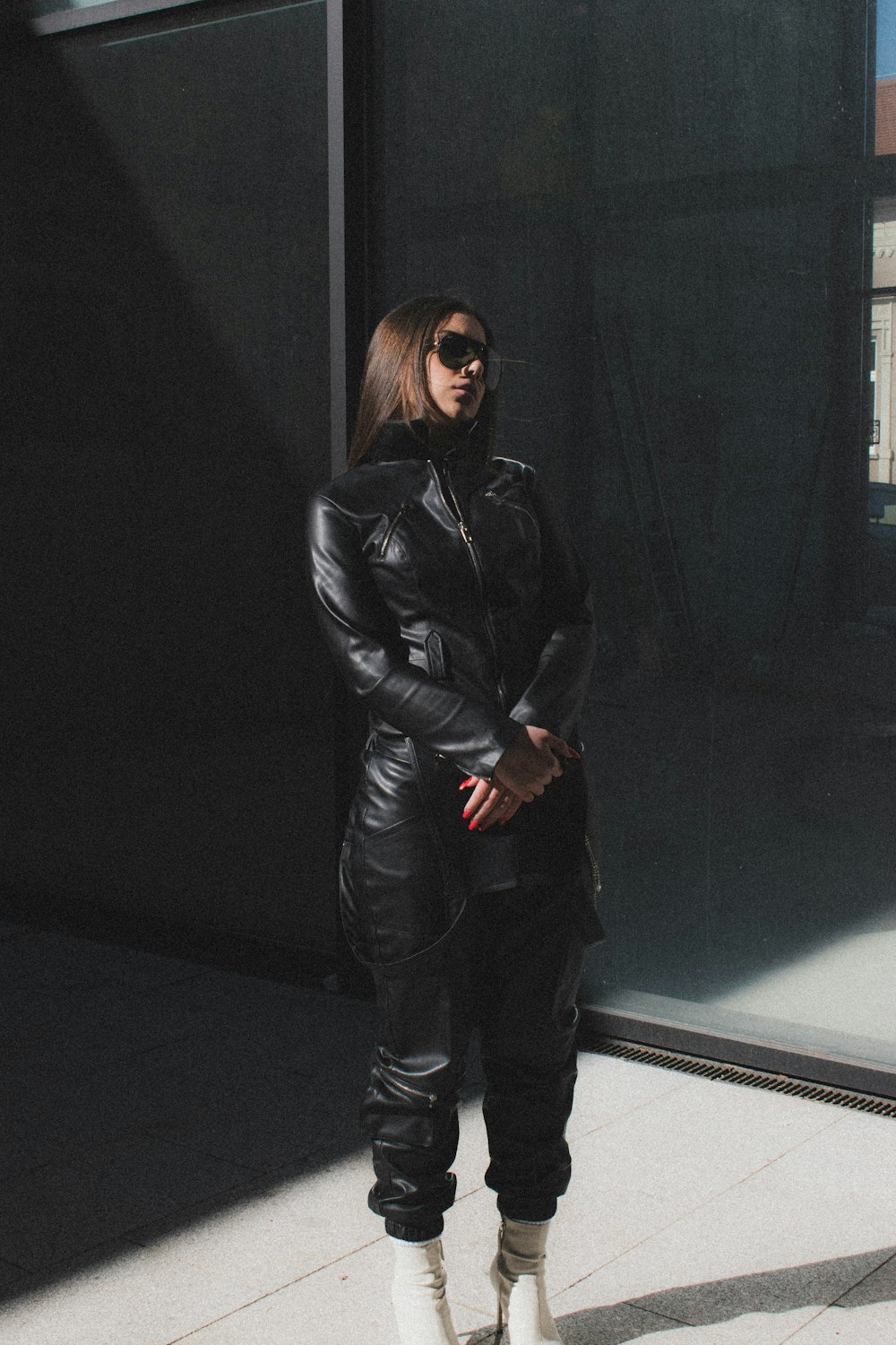 woman in black leather jacket standing