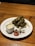 A close-up of a plate filled with beautifully arranged Armenian tolma with grape leaves.