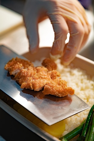 person holding brown cookies on blue ceramic plate