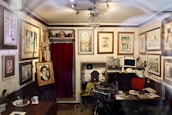 The cozy interior of Kathryn’s studio with prints displayed on walls and shelves.