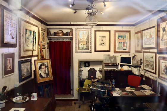 An intimate studio corner showing sketches and animation frames pinned around a warm wooden workspace.