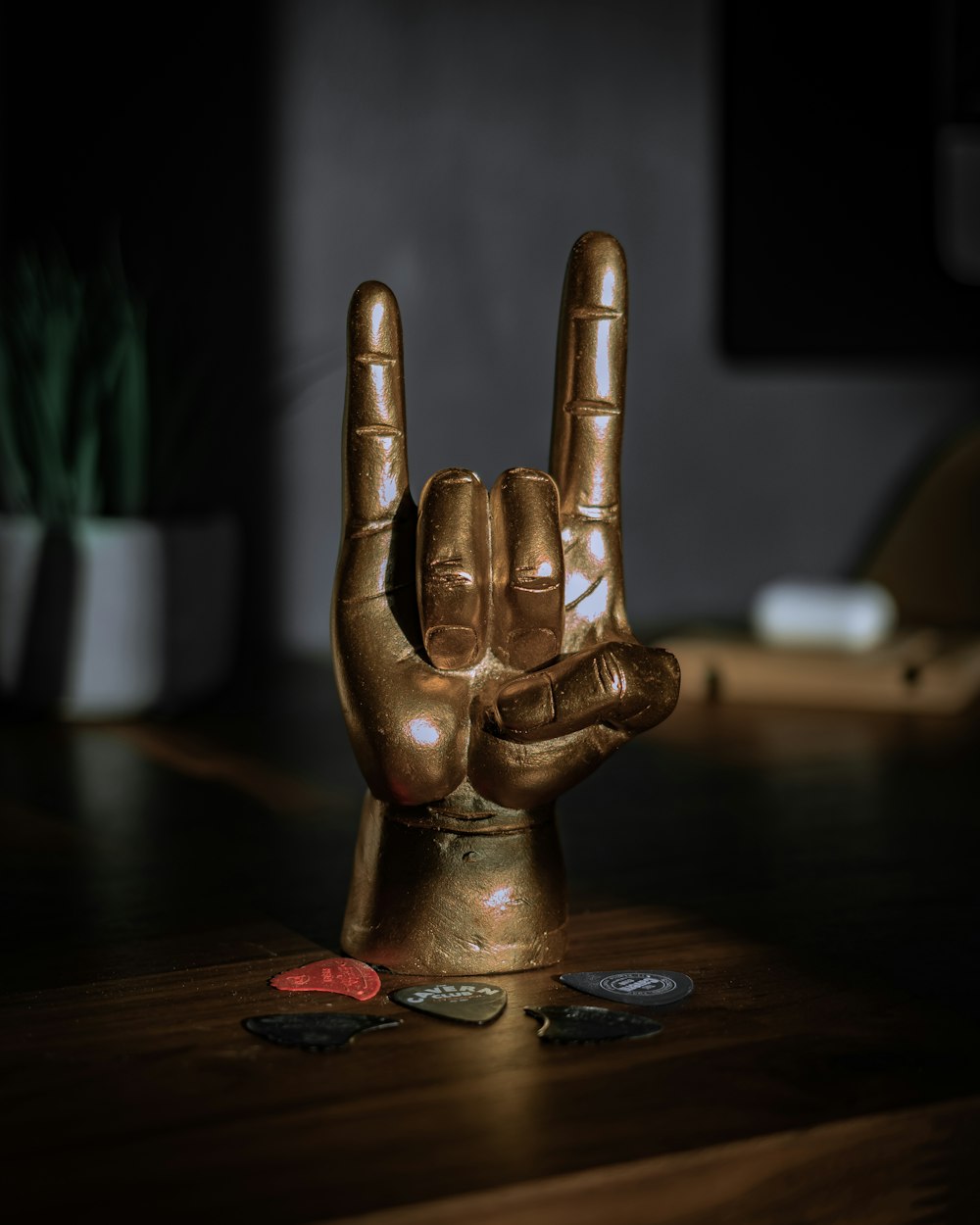 gold human figurine on brown wooden table