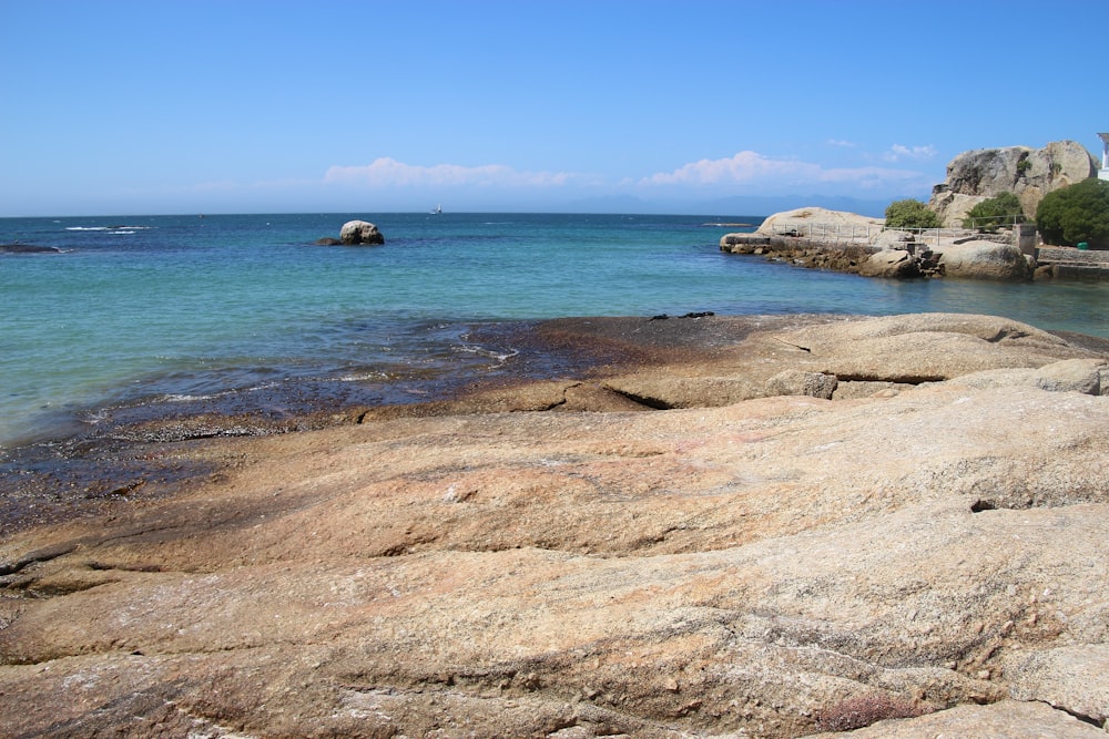 brown rock formation on sea shore during daytime