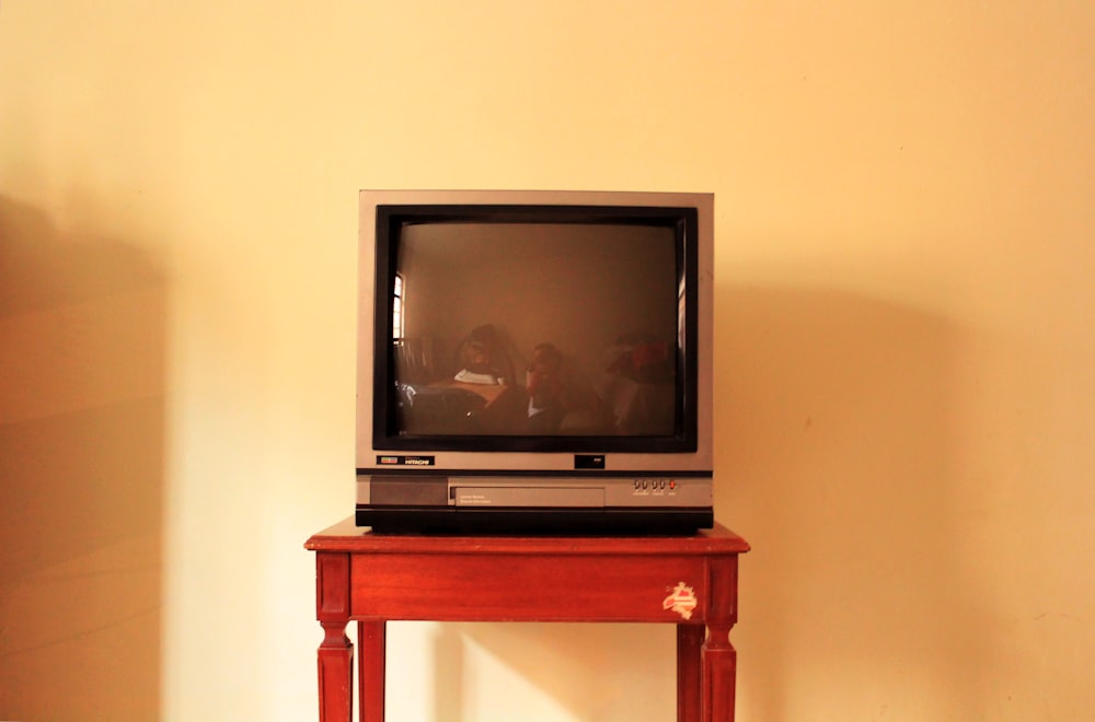 black crt tv on brown wooden table