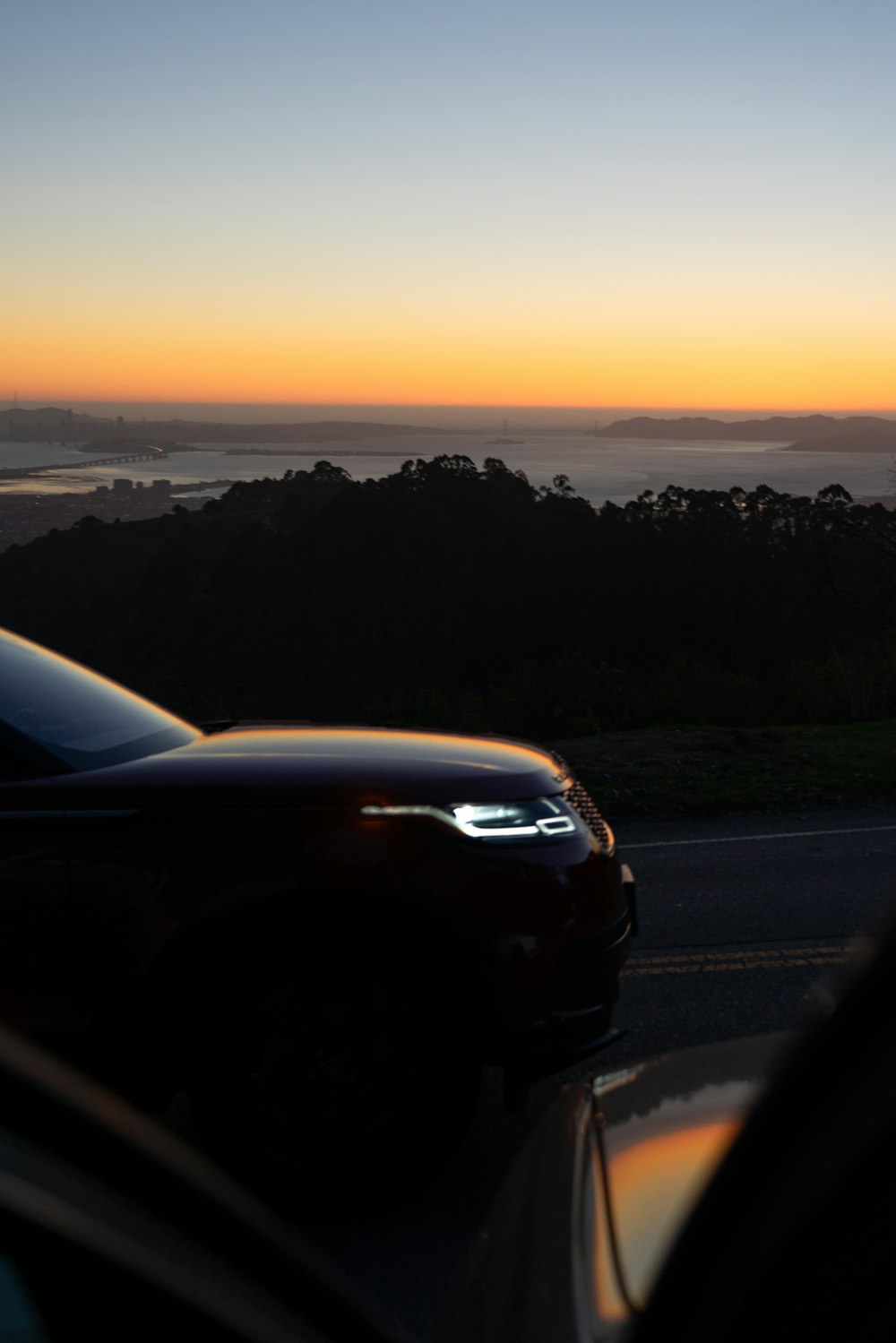 black car on road during sunset