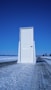 white wooden door near body of water during daytime
