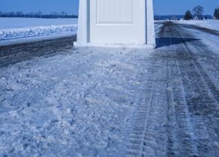 white wooden door near body of water during daytime