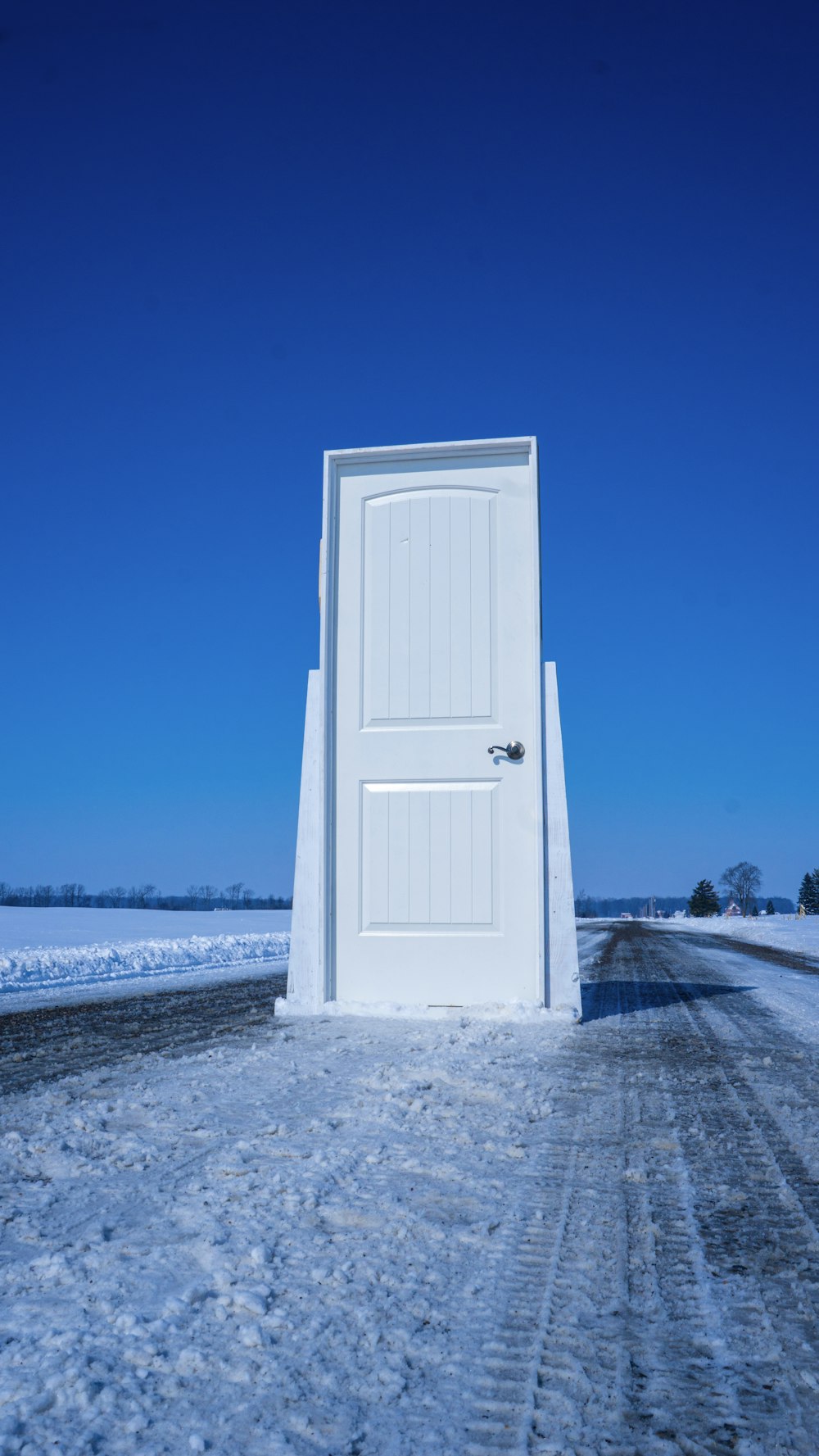 white wooden door near body of water during daytime