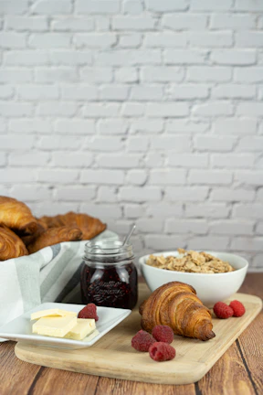 A delicious breakfast spread featuring fresh local fruits and artisan bread on a rustic table.