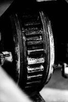 Close-up of a worn transmission gear being inspected on a workbench