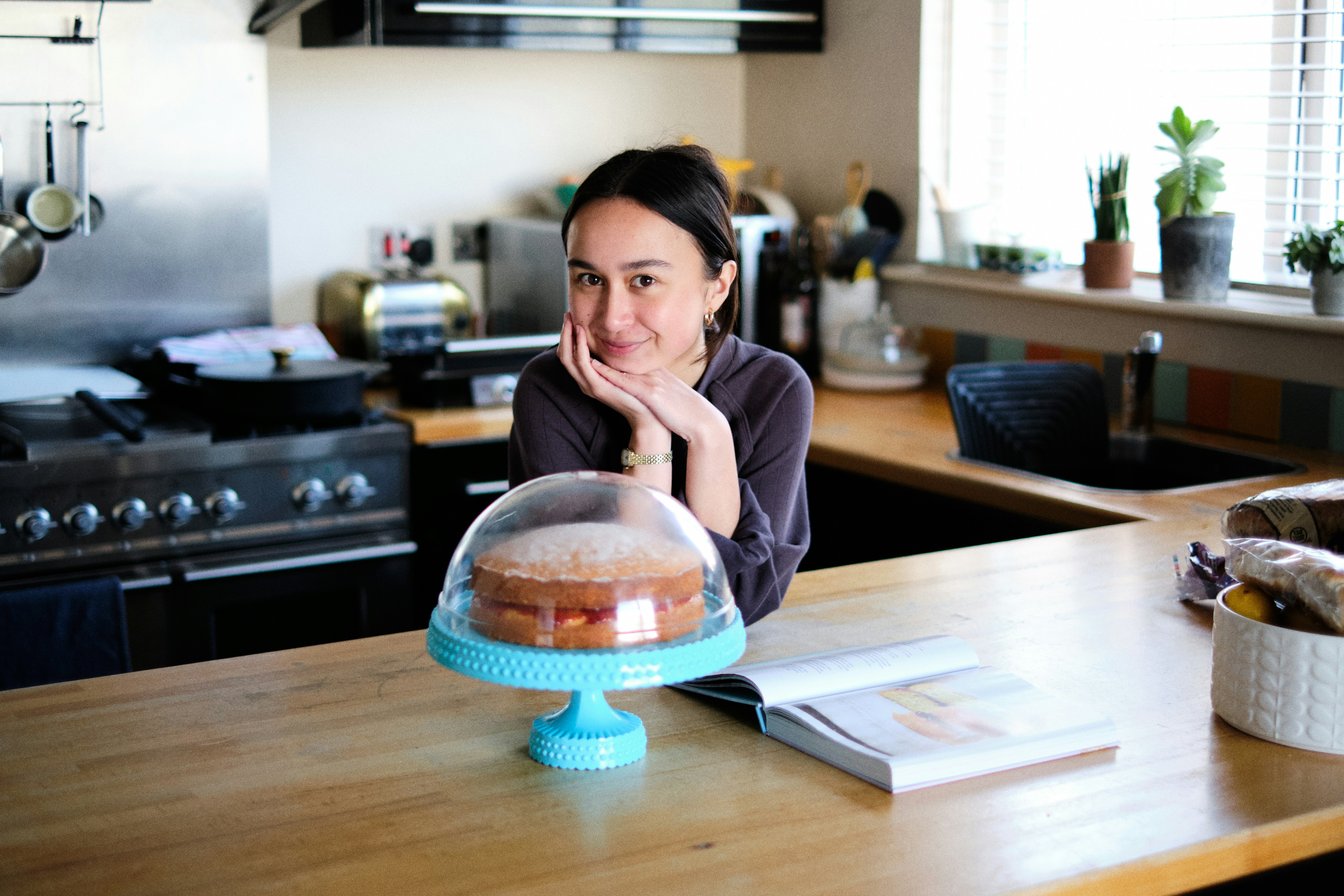 woman in pink long sleeve shirt sitting at the table