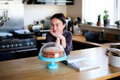 woman in pink long sleeve shirt sitting at the table