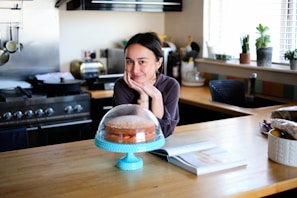 woman in pink long sleeve shirt sitting at the table