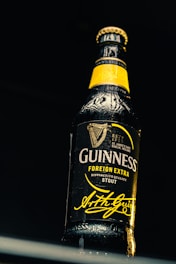 Close-up of a custom beer bottle label featuring a company logo on a wooden table.