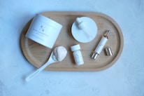 Close-up of skincare products arranged neatly on a wooden table.