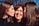 woman in black turtleneck shirt smiling beside woman in black shirt
