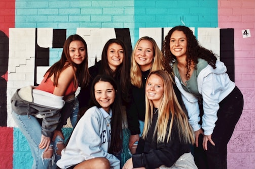 4 women and 2 men smiling