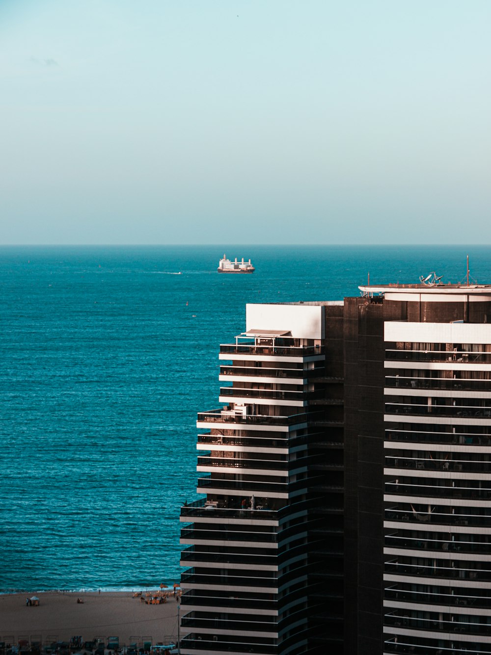 Edificio de hormigón blanco y negro cerca del mar durante el día