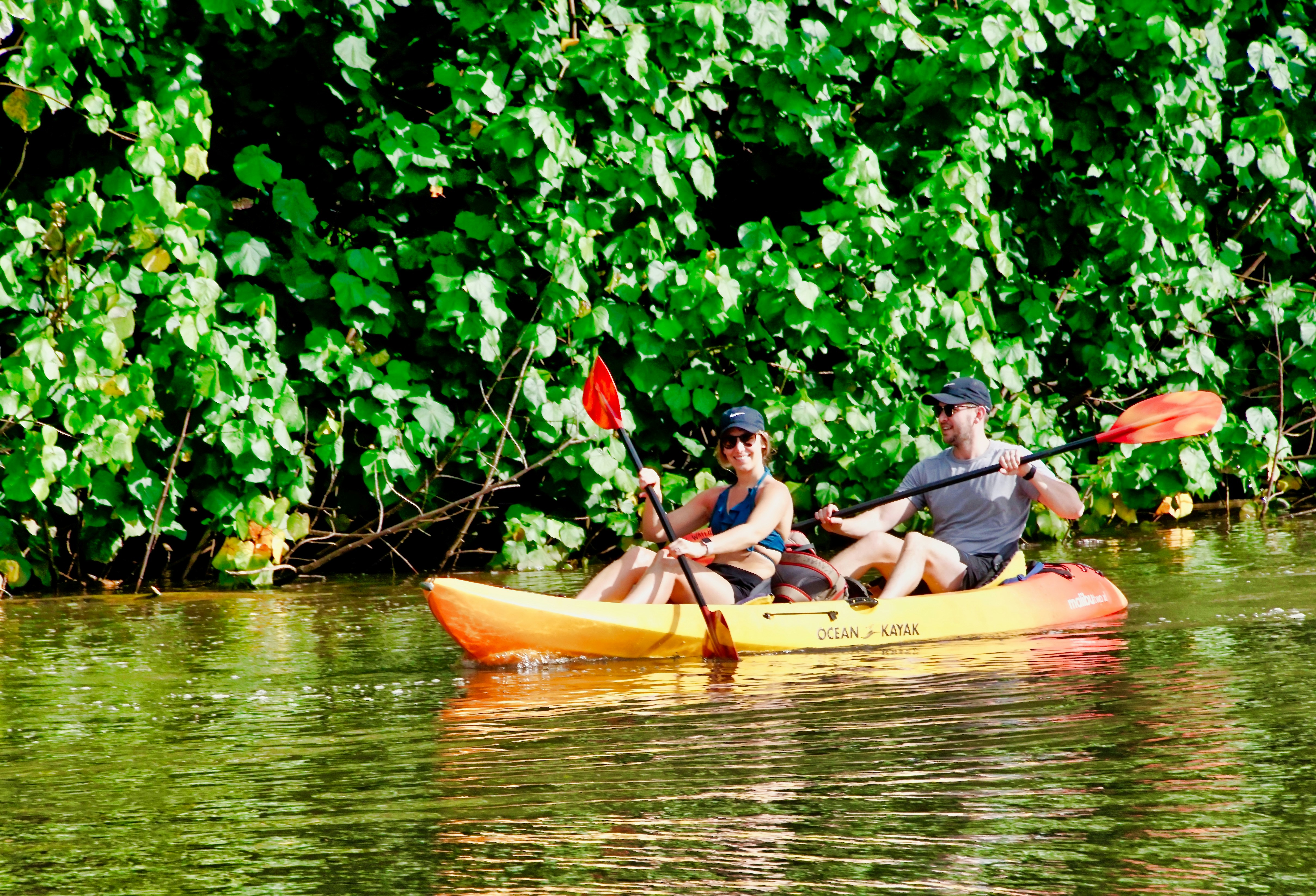 2 men riding on yellow kayak on river during daytime, 