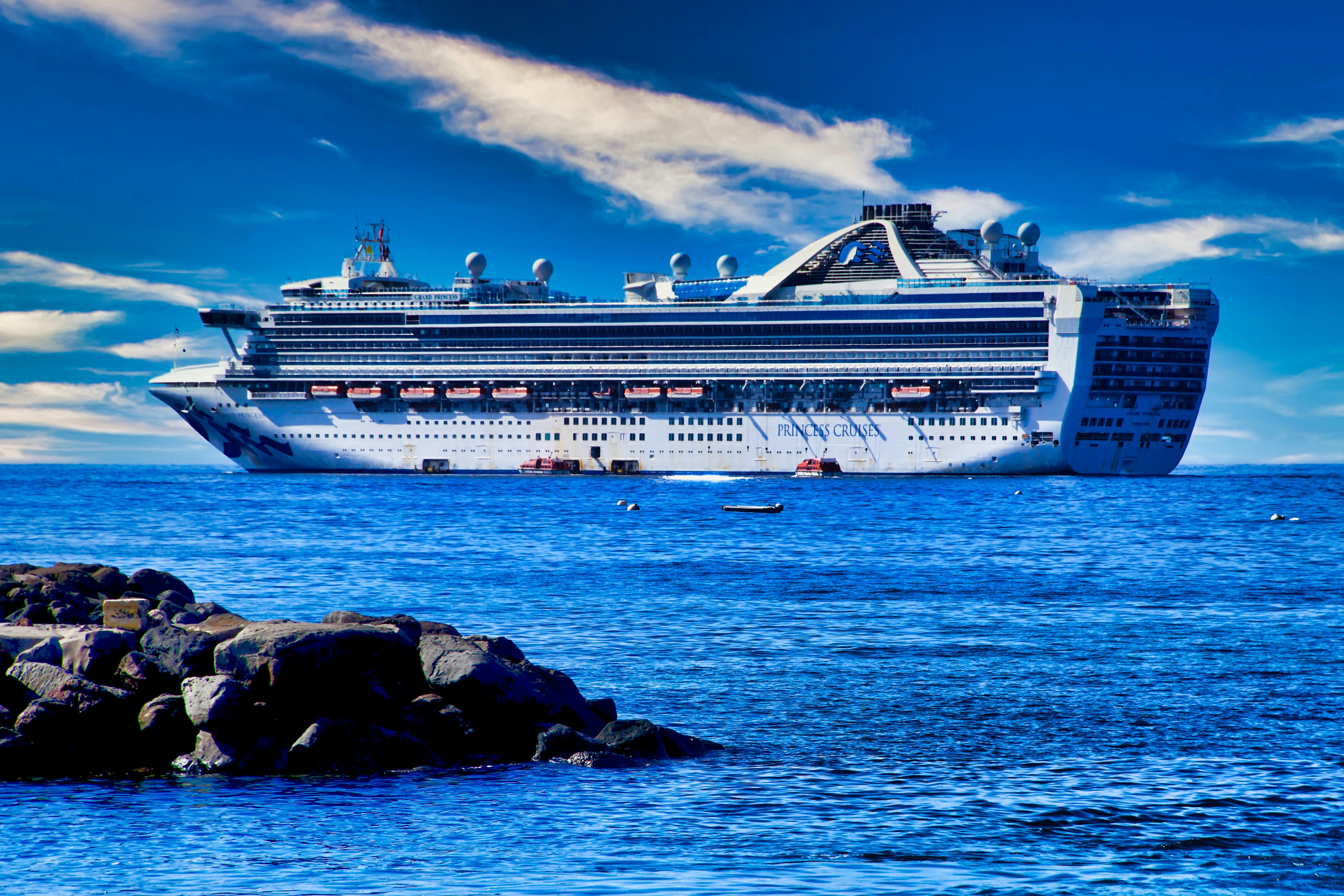 white cruise ship on sea under blue sky and white clouds during daytime, The Grand Princess docked at Maui harbor.