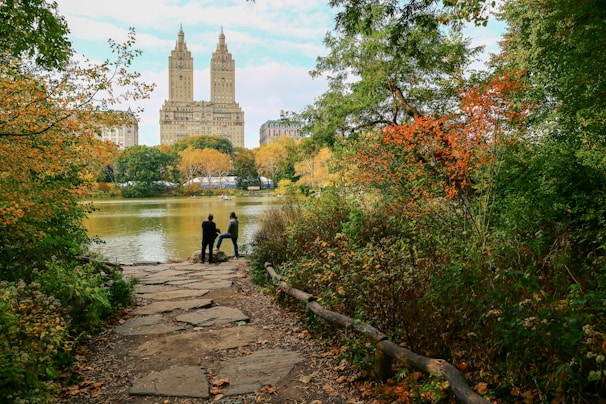 people walking on pathway near body of water during daytime
