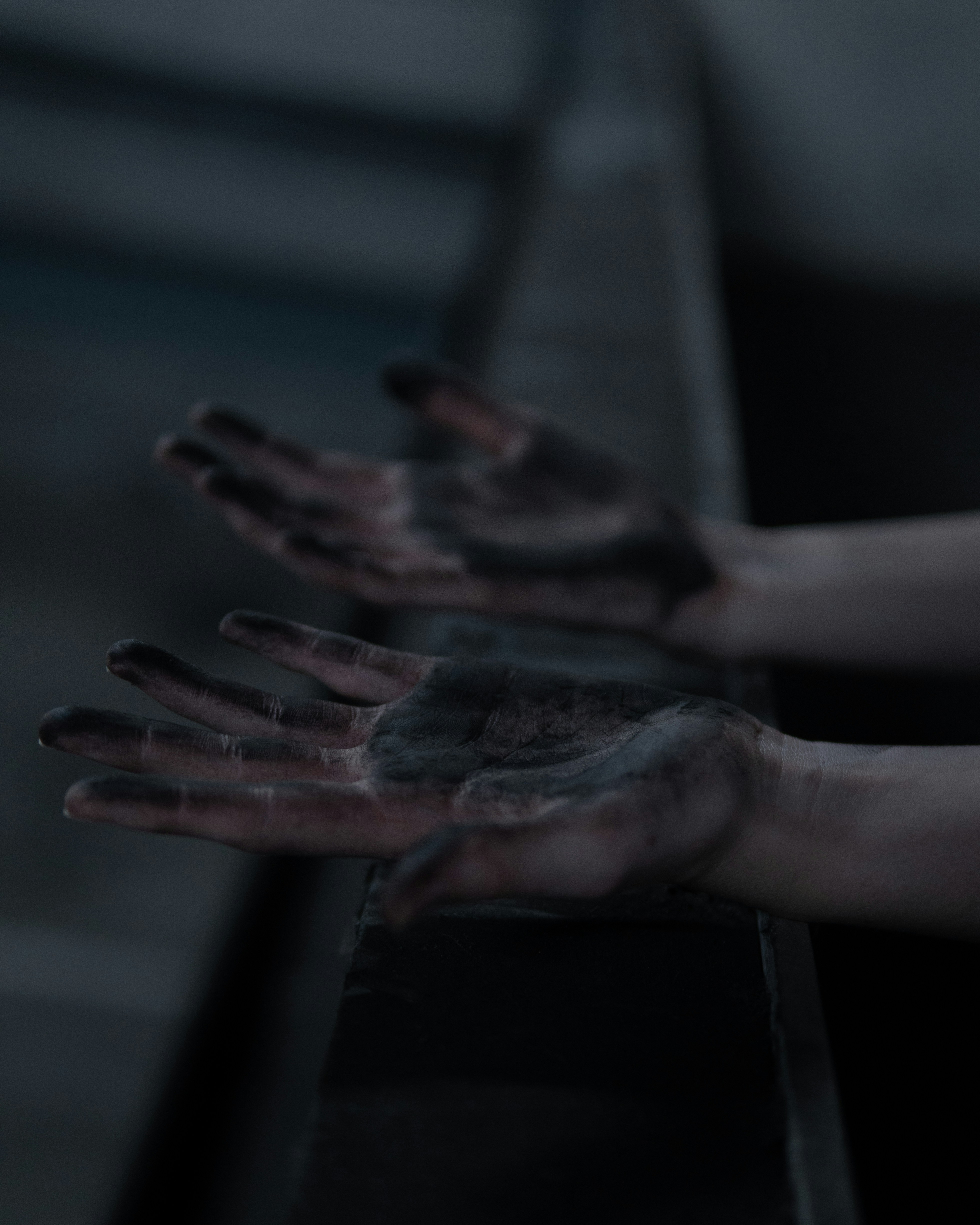 persons left hand with black paint