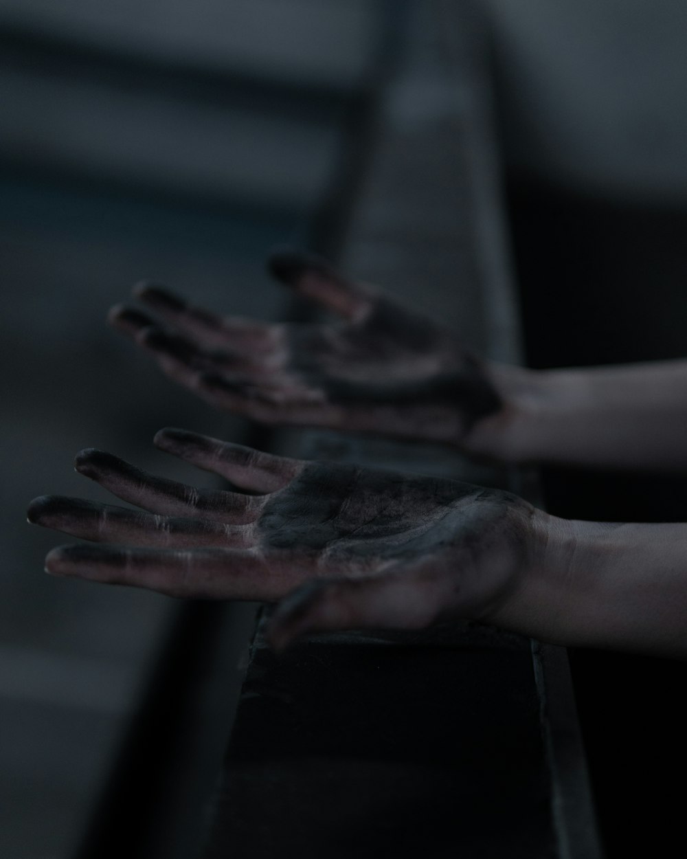 persons left hand with black paint