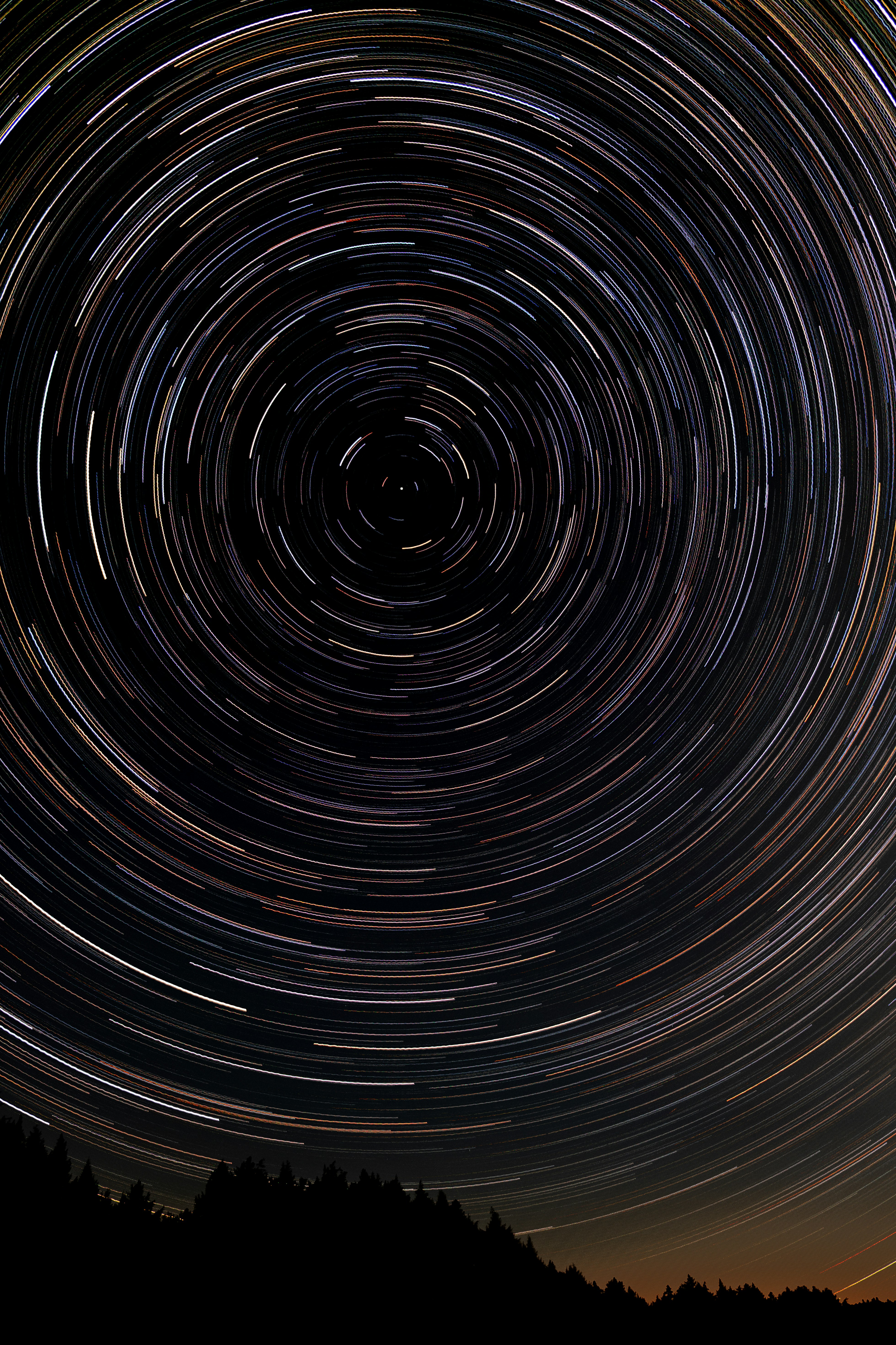 great photo recipe,how to photograph long exposure star trails centered on north star with trees silhouetted in foreground. ; black and white spiral illustration