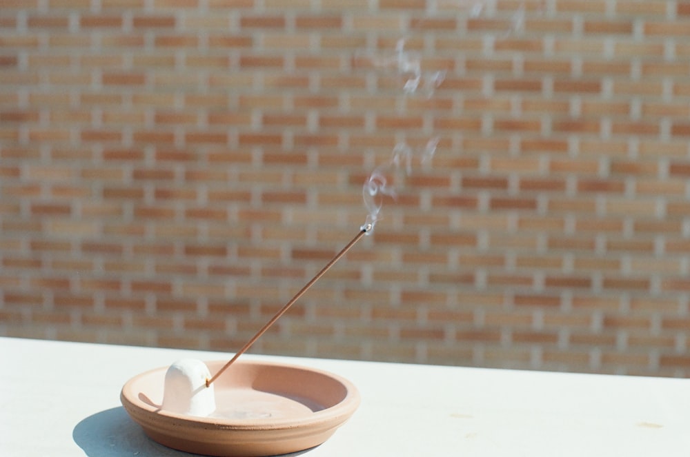 silver spoon on brown ceramic bowl