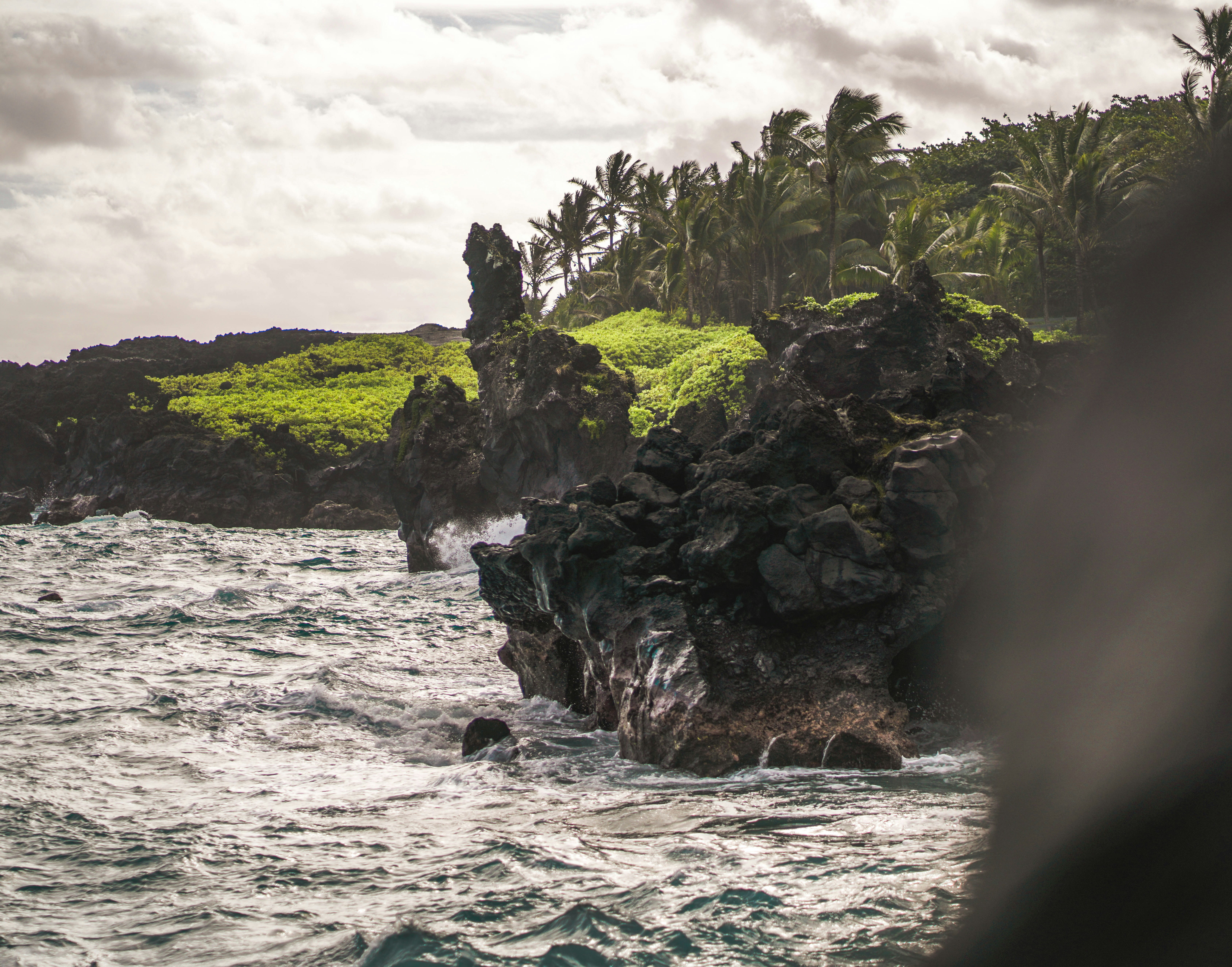a body of water with a rock formation in the middle of it