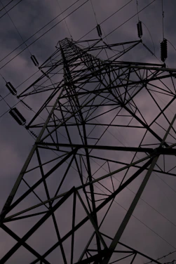 A rugged steel beam structure rising against a clear sky, symbolizing strength and durability.