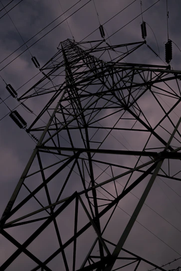A rugged steel beam structure rising against a clear sky, symbolizing strength and durability.