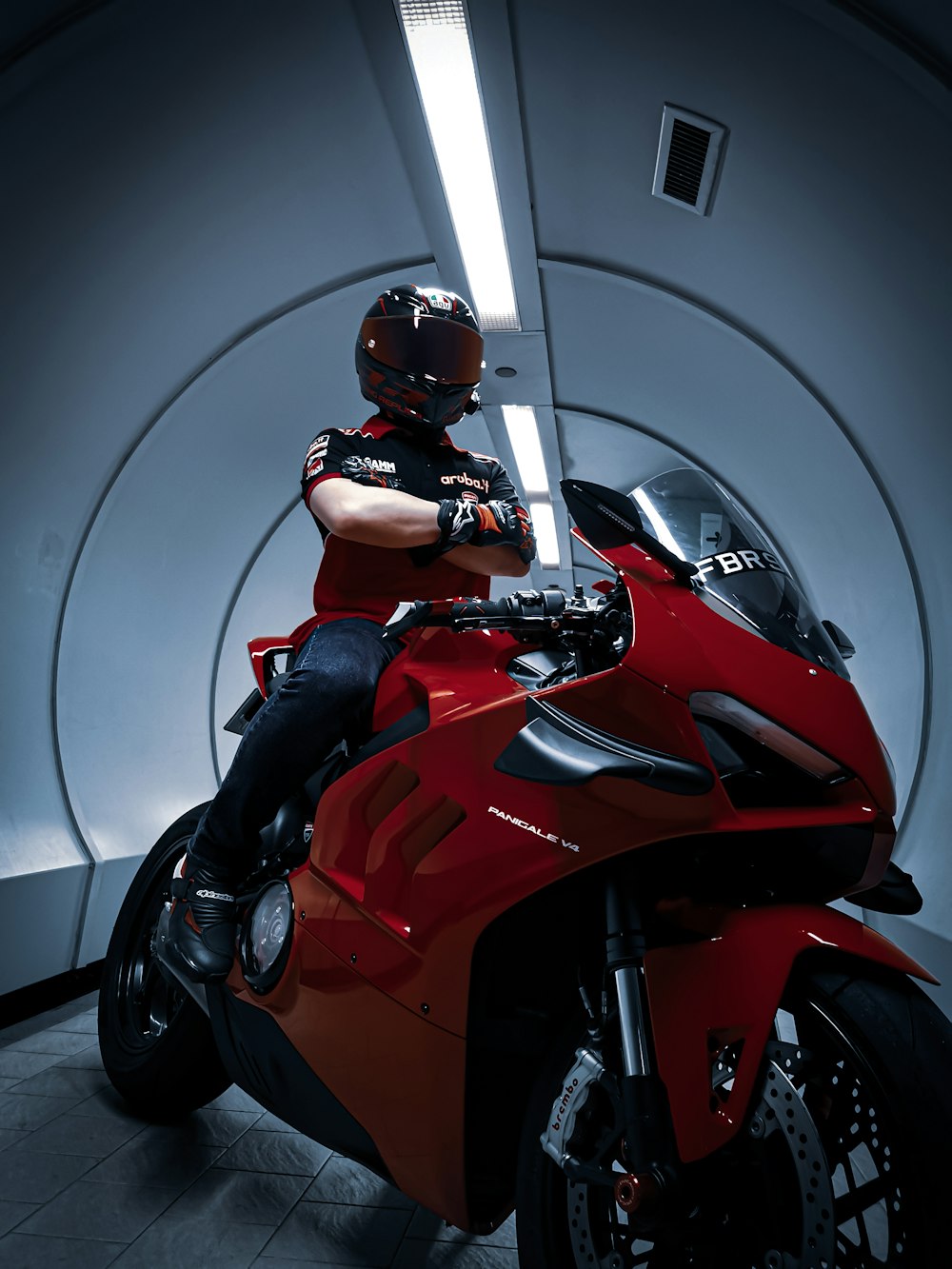 man in black helmet riding red sports bike