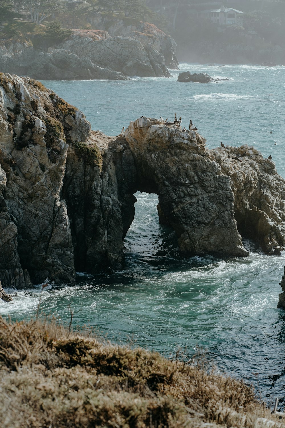 brown rock formation on sea during daytime