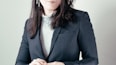 woman in gray turtleneck sweater and gray blazer
