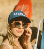 woman in black and blue fitted cap and black sunglasses