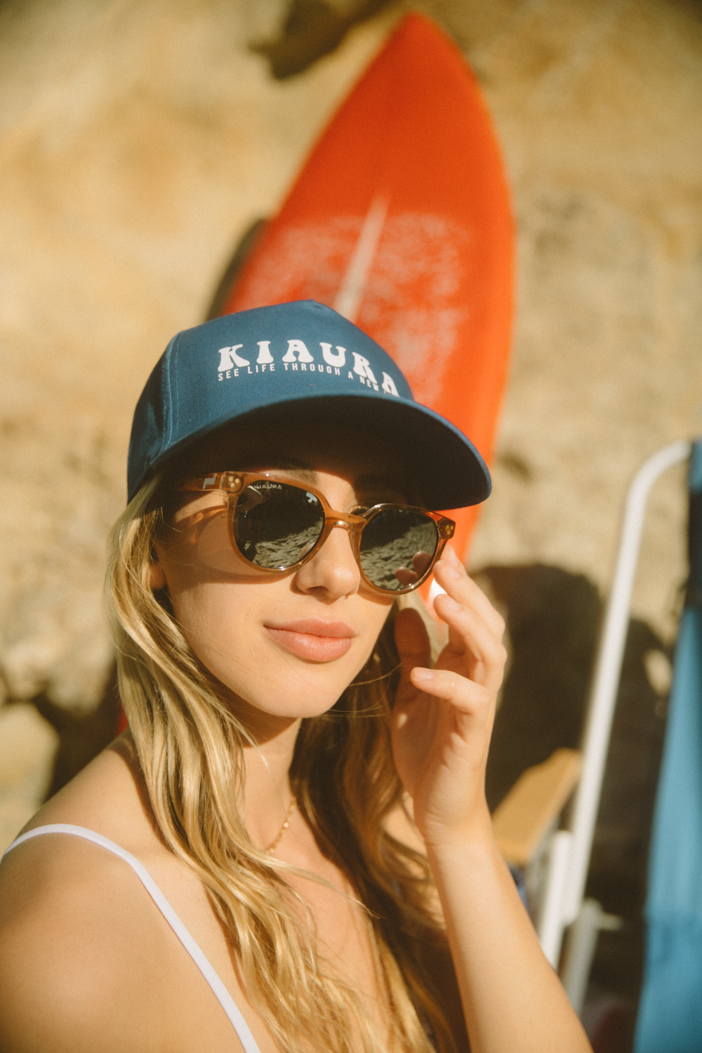 woman in black and blue fitted cap and black sunglasses