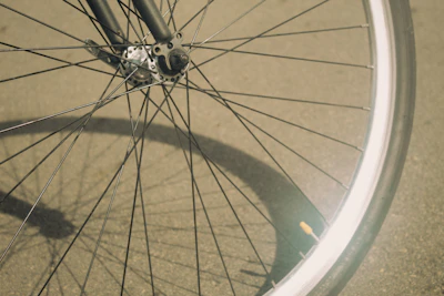 A close-up of a shiny Hero bicycle wheel gleaming under sunlight at Royal Cycle Store.