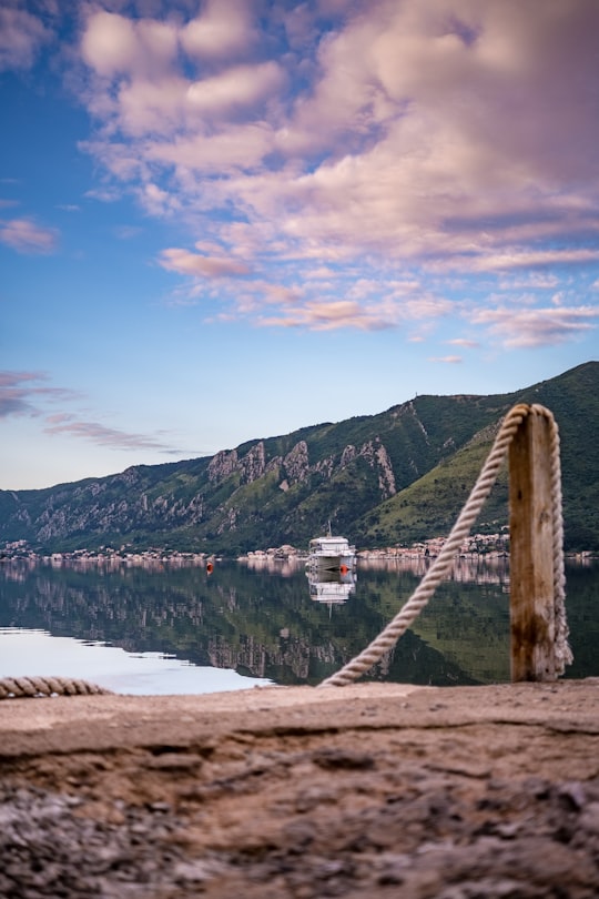 brown wooden bridge over river during daytime in Dobrota Montenegro