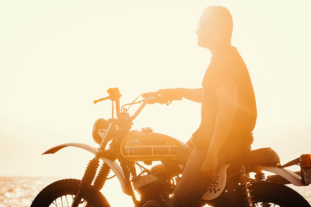 man and woman kissing on motorcycle