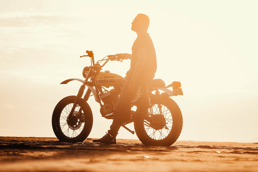 a man standing next to a dirt bike