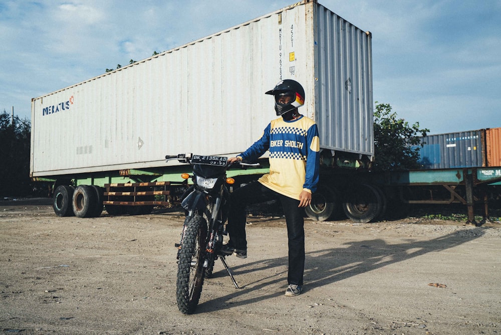 man in black jacket riding on black motorcycle during daytime